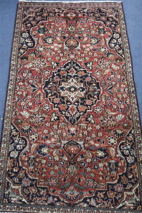 A Kashan red ground rug, 5ft 3in by 2ft 1in.